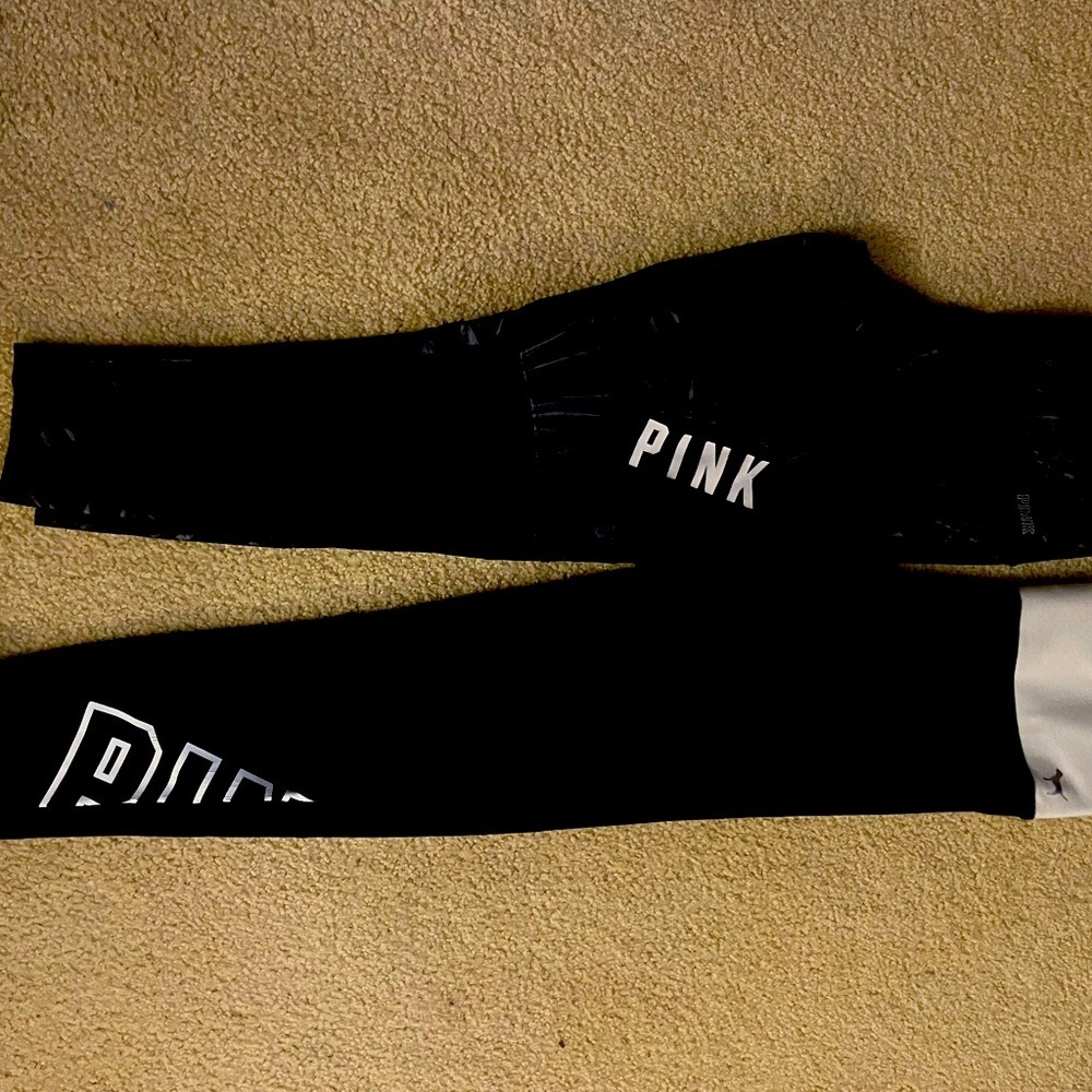 Two pairs of pink stretch, pants and yoga pants